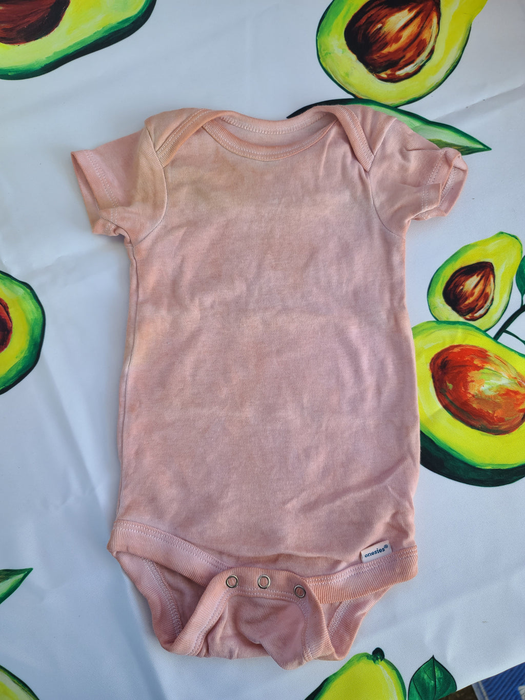 Avocado pit tie-dye baby onsie