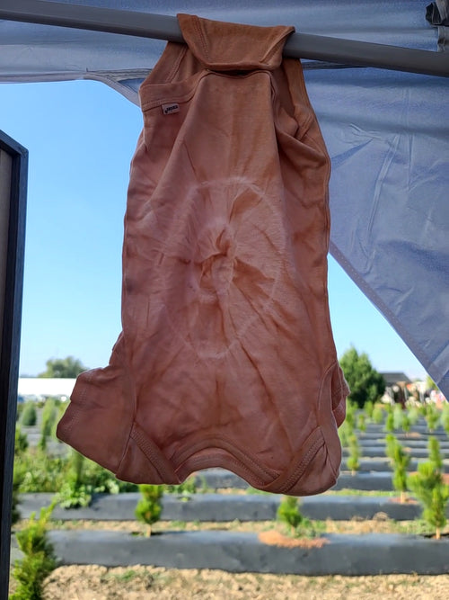 Avocado pit tie-dye baby onsie